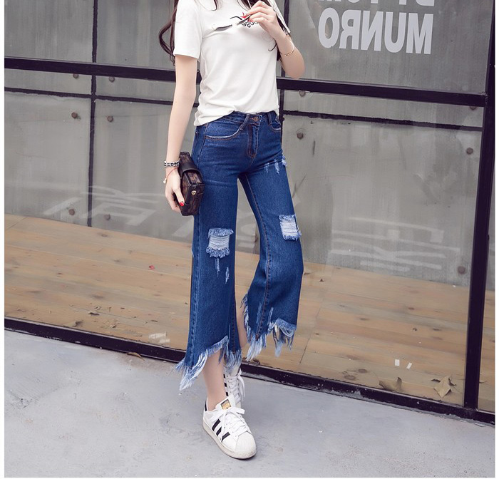 Wholesale-holes-worn-irregular-tassel-flare-jeans